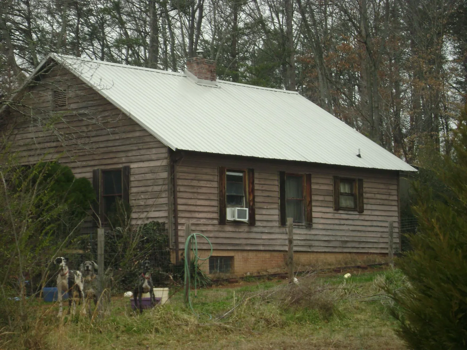 White metal roof on an old wood sided farmhouse, from a Metal Roof Installation job in Aliquippa